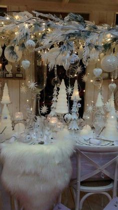 a table topped with lots of white christmas decorations