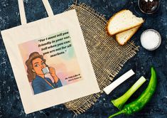 a tote bag sitting on top of a table next to some vegetables and bread