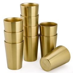 gold colored cups are stacked on top of each other