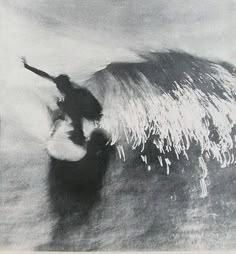 a man riding a wave on top of a surfboard