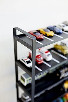 toy cars are lined up on top of each other in this display case for the model car enthusiast