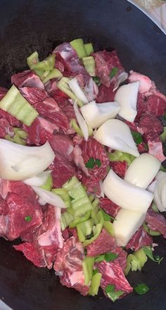 meat and onions cooking in a pan on the stove