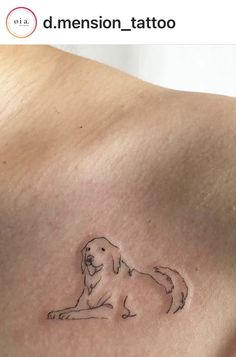 a small dog tattoo on the back of a man's upper arm and chest