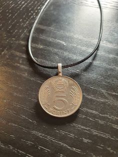 Length: 18 Inches This beautiful necklace is made from an original and authentic coin. It can be combined with many outfits or serve as a beautiful memory of travel and holidays. Thus, emotions are also related to it, which are called up from time to time. A very beautiful coin for every occasion More of my articles: https://www.etsy.com/de/shop/CoinCraftShop Silver Brass Amulet Coin Necklace, Vintage Metal Coin Necklace, Handmade, Cheap Antique Coin-shaped Necklaces, Sterling Silver Amulet Coin Necklace, Tarnish Resistant, Vintage Tarnish-resistant Coin Necklace, Alex And Ani Charm Bracelet, Silver Color, Beautiful Necklaces, Etsy Vintage