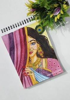 a spiral notebook with an image of a woman on the cover and flowers in the background