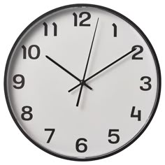 a black and white clock with numbers on the face is showing eleven o'clock