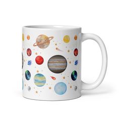 a white coffee mug with planets on it