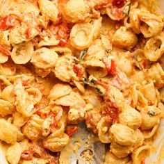 a bowl filled with pasta and meat covered in sauce