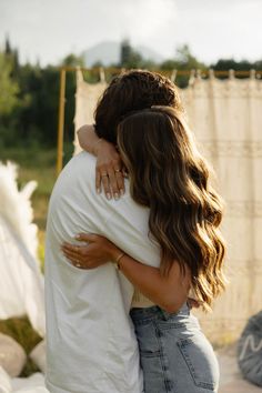 two people hugging each other in front of a shower