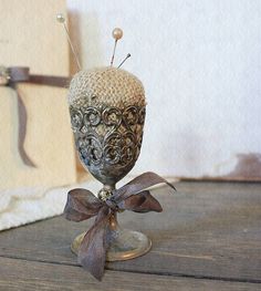 a vase sitting on top of a wooden table next to a white wall and door