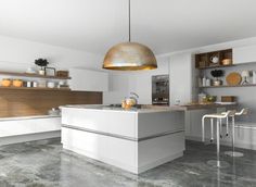 a modern kitchen with white cabinets and counter tops