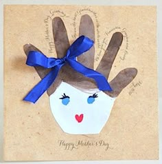 a hand made card with a blue ribbon on it and an image of a woman's face