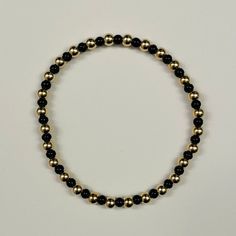 This listing is for a custom 14k gold filled 4mm beaded bracelet with alternating black colored seed beads. Each bracelet can be personalized to your desired length. These bracelets will not tarnish and look great alone or in a stack! Bracelets come in an organza pouch and make perfect gifts. Bracelets are made on elastic cord and will stretch to fit over your hand. Please contact me with any questions. Gifts Bracelets, Stack Bracelets, Organza Pouch, Initial Bracelet, Personalized Initials, Gem Stones, Photo Bracelet, Gold Beads, Black Beads