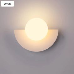 a white wall light on the side of a gray wall