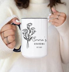 a woman is holding a coffee mug with flowers on it and the words grandma's grandma