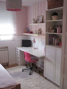 a pink and white bedroom with a desk, chair, bookshelf and window