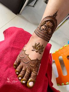 a woman's hand with henna tattoos on it