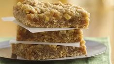 three bars stacked on top of each other on a white plate with green napkins