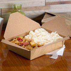 an open take out box with rice and other food in it on a wooden table