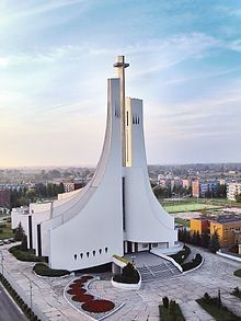 an aerial view of a large church with a cross on the front and side of it