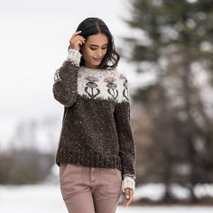 a woman is standing in the snow with her hand on her head