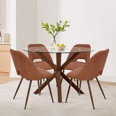 a glass table with four chairs around it