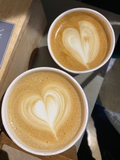 two cups of coffee with hearts on them