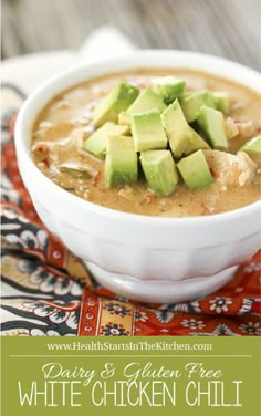 a bowl of white chicken chili with avocado on top and text overlay reading dairy & gluen free white chicken chili