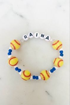 a personalized bracelet with baseballs on it and the word rain written in white letters