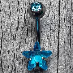 a blue jeweled navel ring with a star design