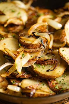 a pan filled with cooked potatoes on top of a wooden table