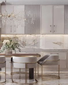 an elegant dining room with white chairs and marble counter tops, chandelier above the table