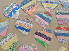 many heart shaped patchwork pieces laid out on a table