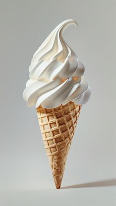 an ice cream cone with white icing on it's tip is shown in front of a gray background