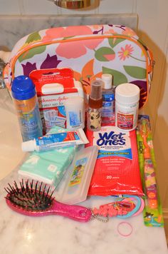 an assortment of personal care items sitting on top of a bathroom counter