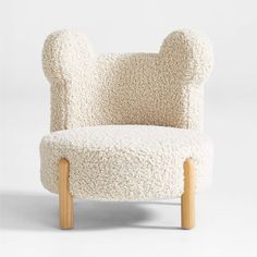 a chair made out of sheep's wool with wooden legs