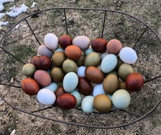 a basket filled with lots of different colored eggs