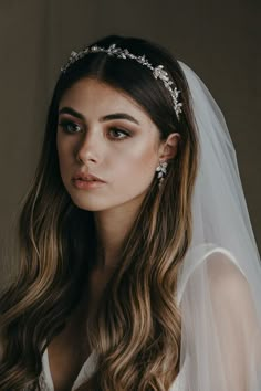 a woman wearing a veil with flowers in her hair