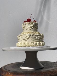 a three tiered cake with a cherry on top