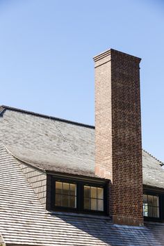 a brick chimney on the roof of a house