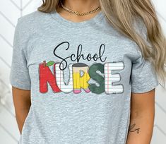 a woman wearing a grey shirt with the words school nurse in colorful letters on it