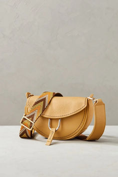 Brighten up your everyday look with the sunny Sol, a petite crescent-shaped shoulder bag with uniquely stylish accents. Modern Textured Leather Saddle Bag, Modern Textured Leather Crossbody Saddle Bag, Trendy Leather Saddle Bag For Work, Leather Pulls, Everyday Look, Crescent