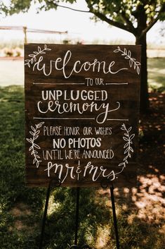 a welcome sign in front of a tree with the words welcome to our unplugged ceremony