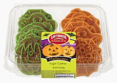 two halloween cookies in a plastic container