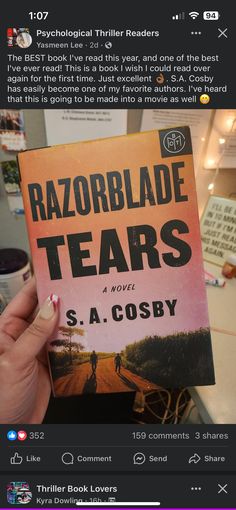 someone holding up a copy of the book razorblade tears by s a cosby