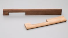 a wooden handle for a door on a gray background