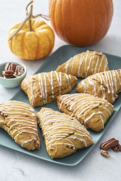 pumpkins and cookies on a blue plate with white glaze drizzled