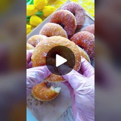 the donuts are being held up by gloved hands