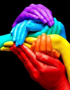 hands painted in different colors holding each other