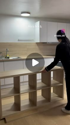 a man standing in front of a kitchen counter top next to a sink and oven